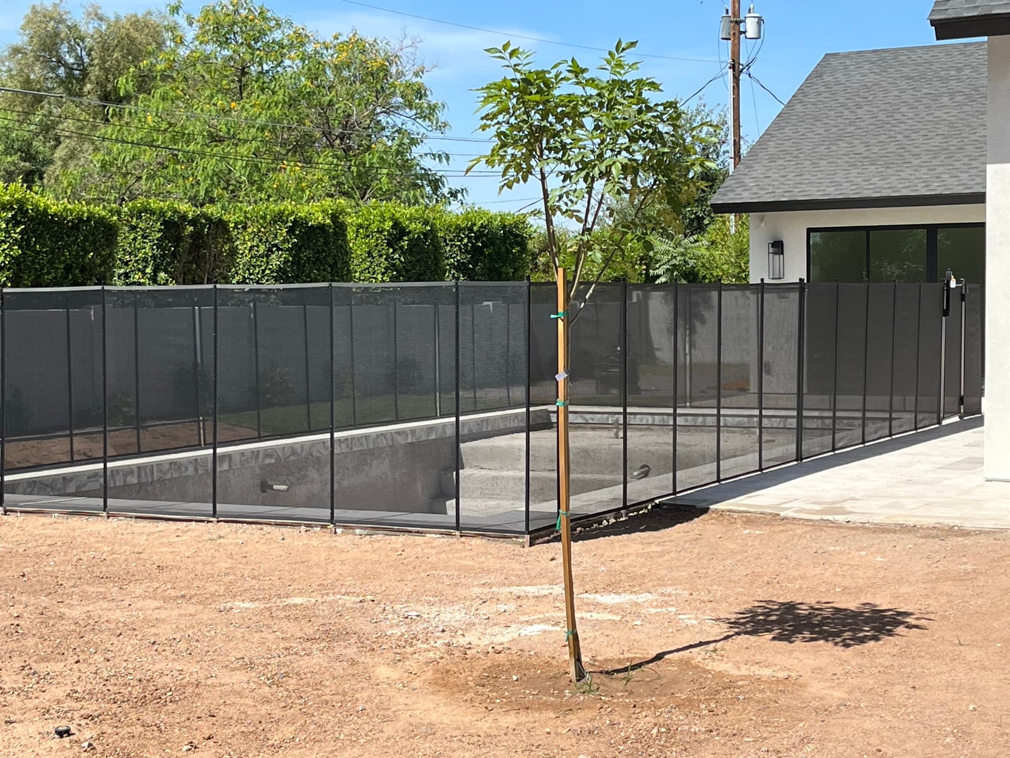 Pool fence gate close-up — self-closing latch