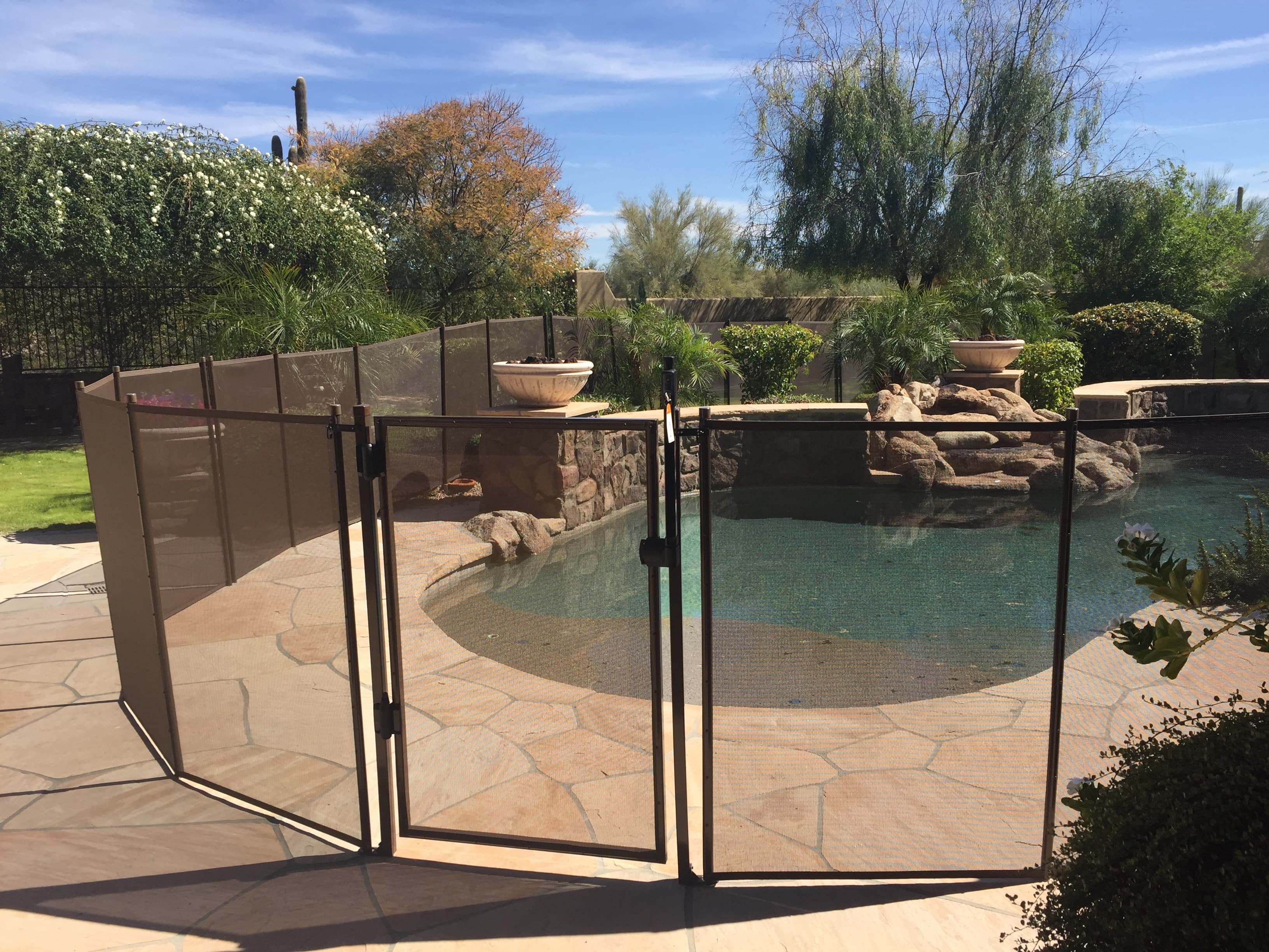Black mesh pool fence installed — Goodyear AZ backyard