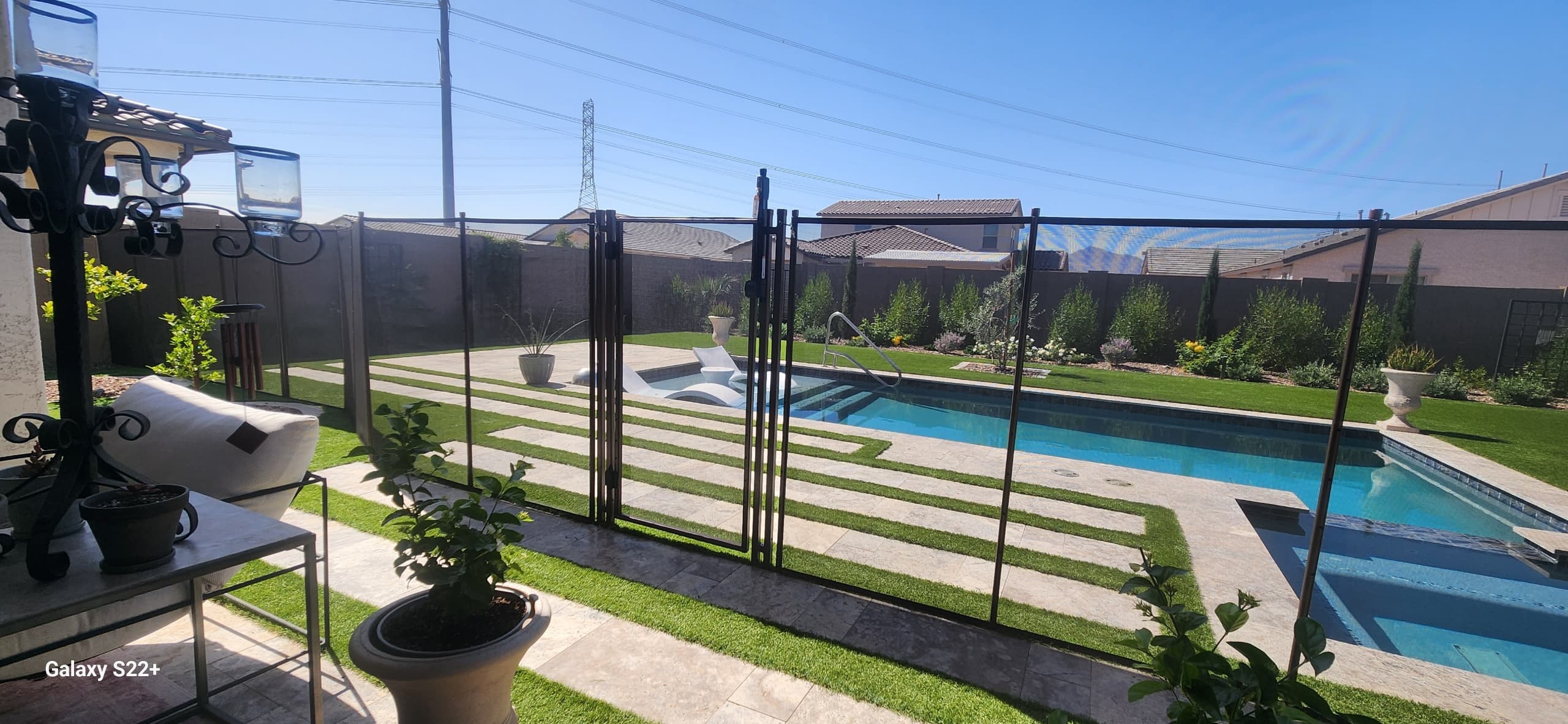 Pool fence around rectangular pool — lush green lawn, Arizona backyard